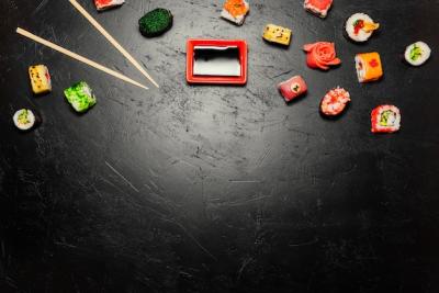 Sushi Rolls and Chopsticks on Black Background – Free Stock Photo for Download