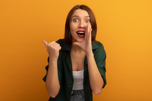 Excited Pretty Caucasian Woman Pointing on Orange Background – Free Stock Photo, Download for Free