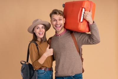 Smiley Couple Ready for Traveling with Luggage – Free Download