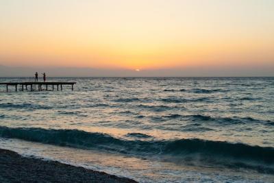 Silhouette of People Walking Along a Sunset Beach Pier – Free Stock Photos for Download