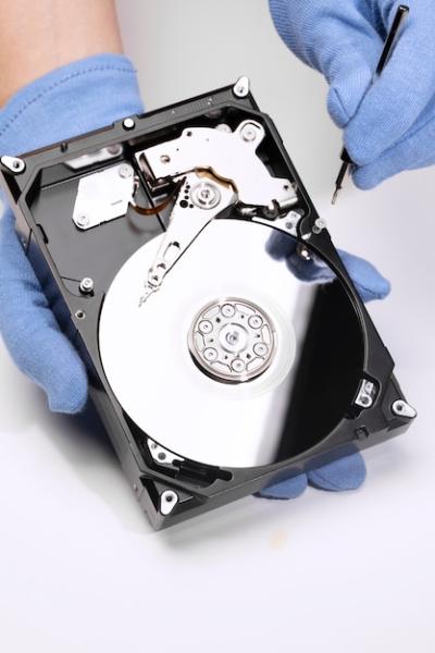 High Angle Photo of Hands Repairing a Hard Drive – Free Download