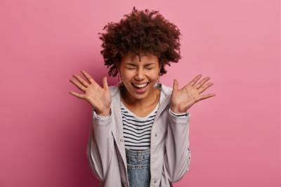 Very Happy Woman Laughing with Joyful Expression on Pink Background – Free Stock Photo Download