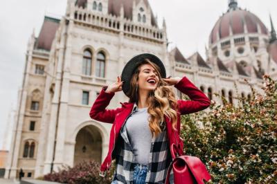 Gorgeous White Woman Posing with Hat Near Historical Site – Free Download