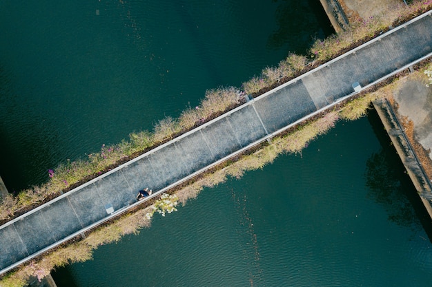 Aerial View of a Person Walking Through a Bridge – Free Stock Photo Download