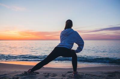 Sport Exercises by a Young Woman at Sunrise Beach – Free Download