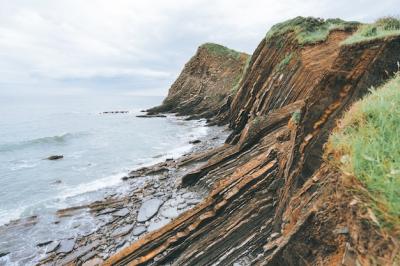 Cliffs Covered in Green Grass Next to Blue Sea – Free Stock Photo, Download for Free