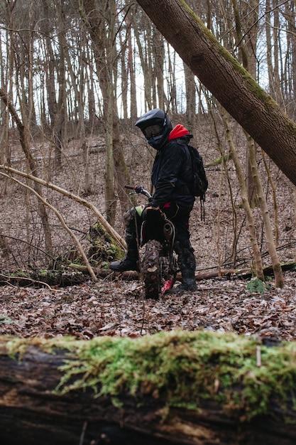 Motorcyclist Preparing for a Ride in a Forest – Free Download