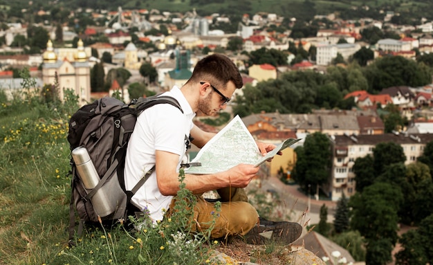 Man Traveling Alone Consulting Map – Free Stock Photo for Download