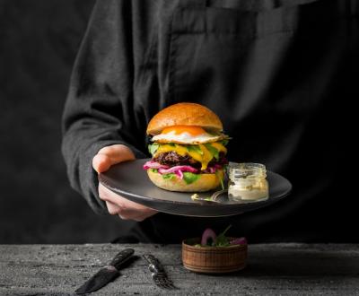 Person Holding a Plate with Burger – Free Download