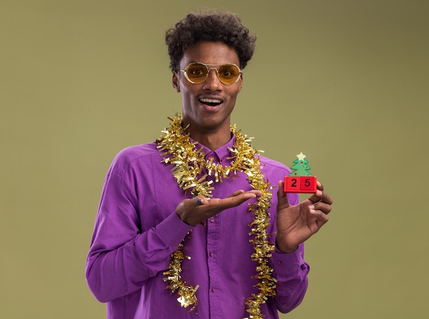 Joyful Afro-American Man with Christmas Tree Toy – Free Stock Photo Download