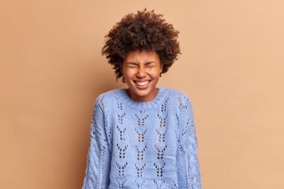 Overjoyed Woman Laughing with Curly Hair – Free Stock Photo for Download