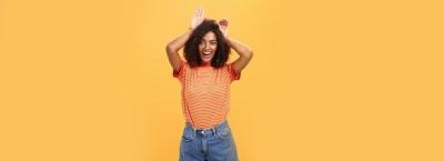 Charming Dark-Skinned Female with Afro Hairstyle in Cute Bunny Pose – Free Stock Photo for Download