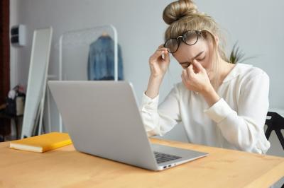 Portrait of a Stressed Young Female Employee Taking Off Her Glasses