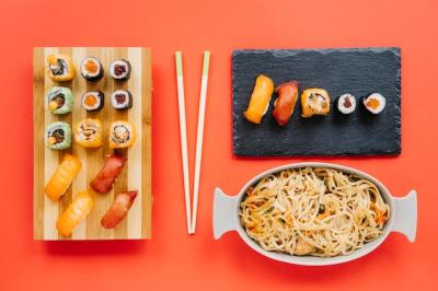 Noodles and Sushi with Chopsticks on Red Background – Free Download