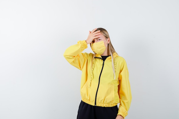 Blonde Lady in Tracksuit and Mask with a Mournful Expression – Free Download