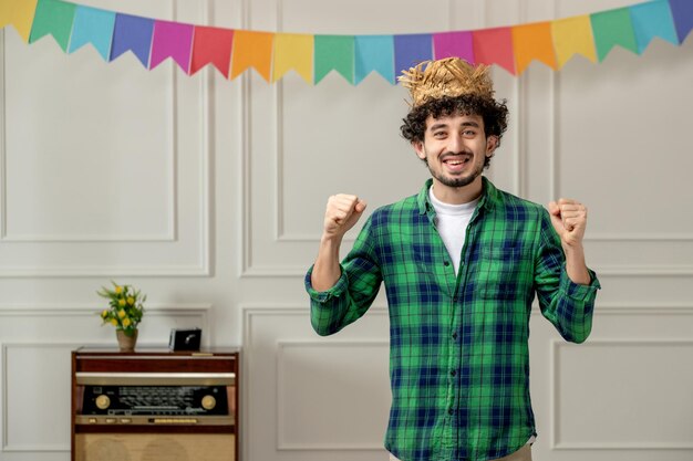 Excited Young Guy in Straw Hat with Retro Radio and Colorful Flags – Free Download