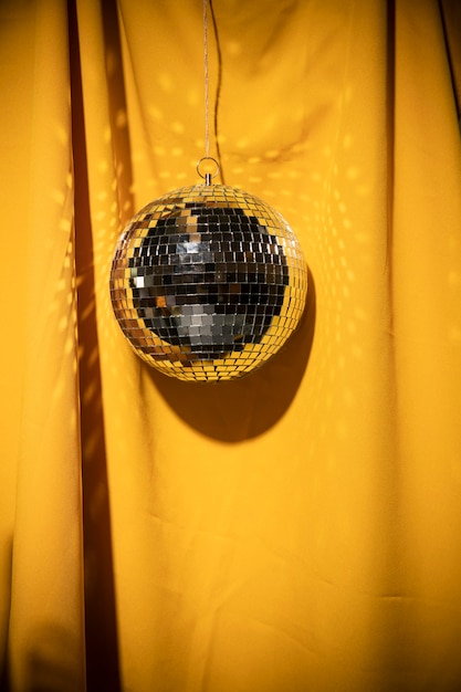 Low Angle Silver Globe Party on Yellow Curtain – Free Download