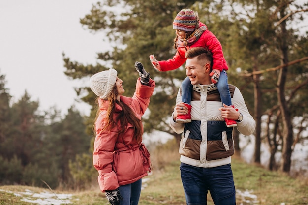 Young Family Enjoying a Winter Walk in the Forest – Free Download