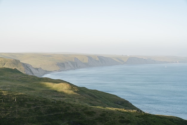 High Angle Shot of Lush Green Hills by the Ocean – Free Download