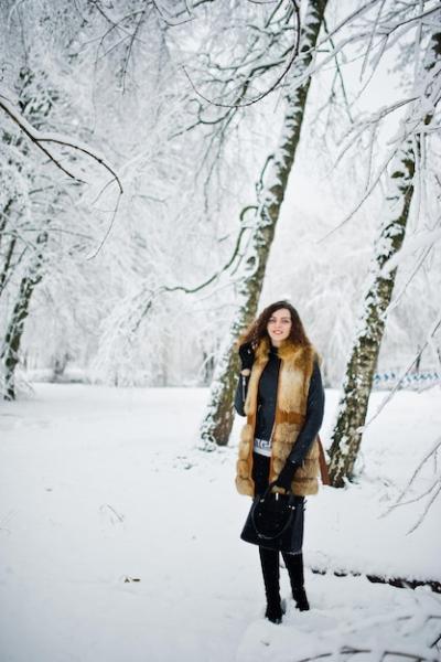 Curly Girl in Elegant Fur Coat and Handbag in a Snowy Winter Forest – Free Download