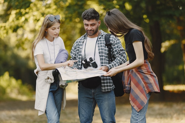 Smiling Friends Hiking in a Forest – Free Stock Photo for Download