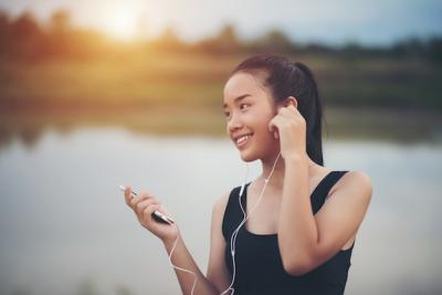 Fitness Woman in Earphones Enjoying Music During Park Workout – Free Download