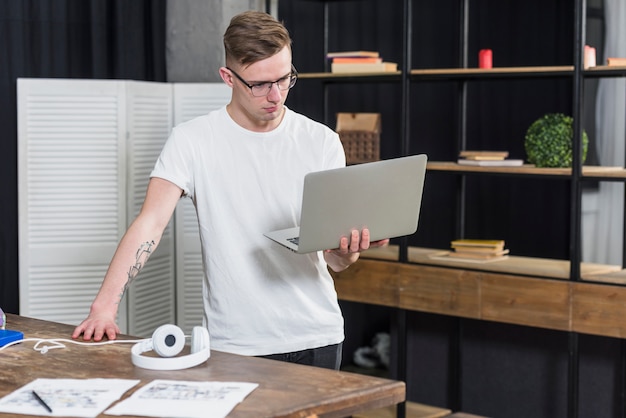 Handsome Young Man Holding Laptop – Download Free Stock Photo