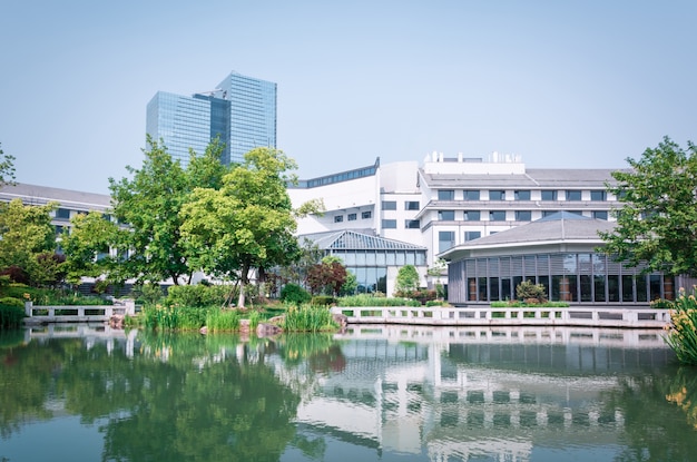 Stunning Glass Buildings Reflected in a Serene Lake – Free Download