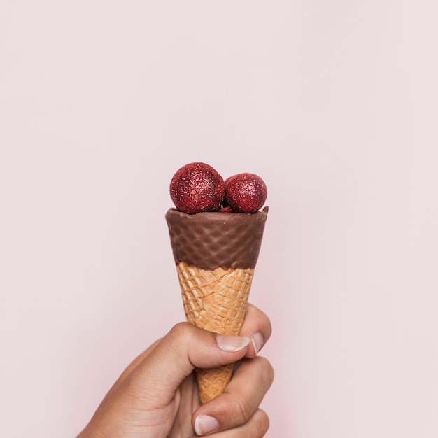 Hand Holding Ice Cream Cone with Red Disco Balls – Free Stock Photo for Download