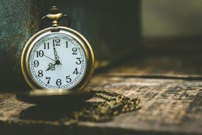 Close-up of Pocket Watch on Wooden Table – Free Download