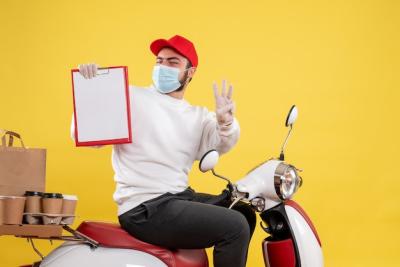 Male Courier in Mask Holding File Note on Yellow – Free Stock Photo, Download for Free