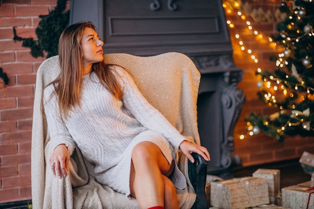 Woman Sitting in Chair by a Christmas Tree – Free Stock Photo, Download for Free