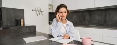 Woman Working from Home with Mobile Phone, Looking Confused – Free Stock Photo for Download