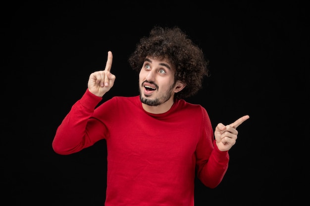 Young Male in Red Shirt Posing Against Black Wall – Free Download