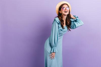 Cheerful Darkhaired Girl Laughing in Sky Blue Outfit on Lilac Background – Free Download