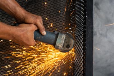 Male Workers Cutting and Welding Metal with Sparks – Free Download