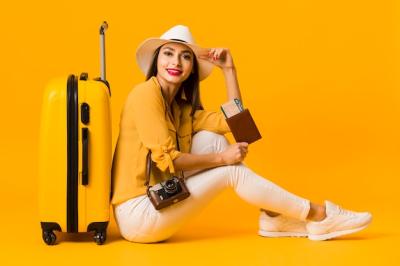 Woman Posing Next to Luggage with Travel Essentials – Free Download