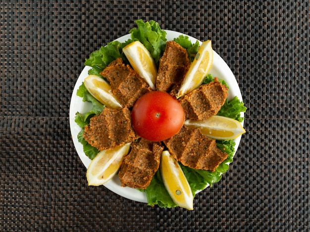 Top View of Turkish Cig Kofte Raw Meatballs with Lettuce and Lemon – Free Stock Photo, Download for Free