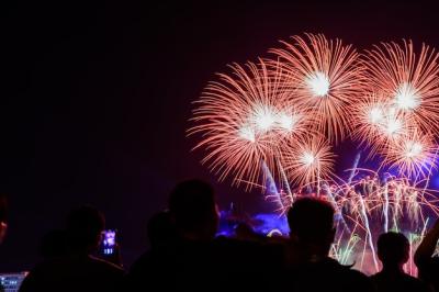 Crowd Celebrating with Fireworks During City Foundation