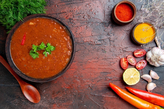 Classic Tomato Soup Surrounded by Spices and Fresh Ingredients – Free Download