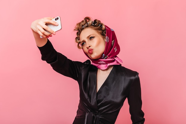 Woman Wearing Silk Blouse and Scarf Taking a Selfie on a Pink Wall – Free Stock Photo, Download for Free