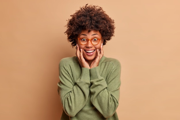 Joyful Woman with Afro Hair Smiling in Sweater – Free Stock Photo Download