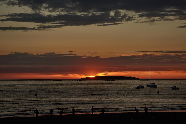 Stunning Sunset in Red Hues Over Playa America with Las Estelas – Free to Download