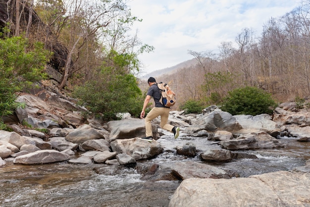 Hiker Crossing Wild River – Free Stock Photo for Download