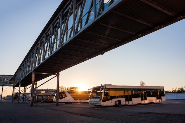 Shuttle Buses at Airport Parking Lot in Sunset Rays – Free Download