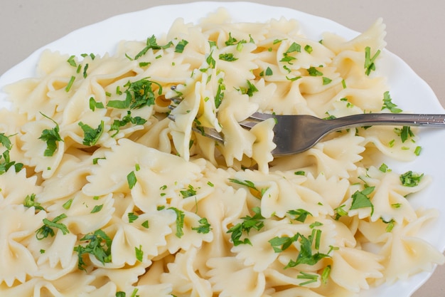 Delicious Farfalle Pasta with Parsley and Fork on White Plate – Free to Download