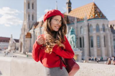 Graceful Girl in Red Outfit Smiling at Old European Castle – Free to Download