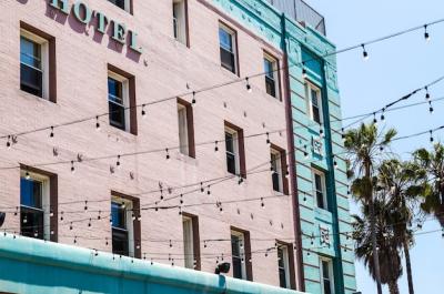 Low Angle Shot of a Hotel Building with Street Lights and Palms – Free Download