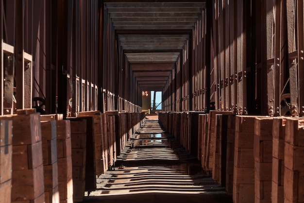 Long Corridor in Industrial Building with Shadows – Free Stock Photo for Download