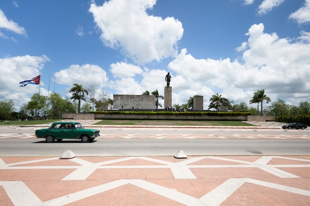 Classic Car Passing in Front of Monument in Cuba – Free Download